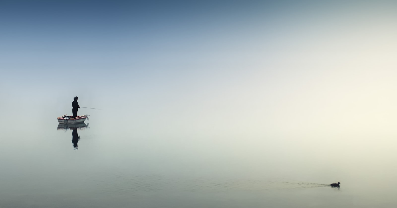 rule of thirds photography of man on boat
